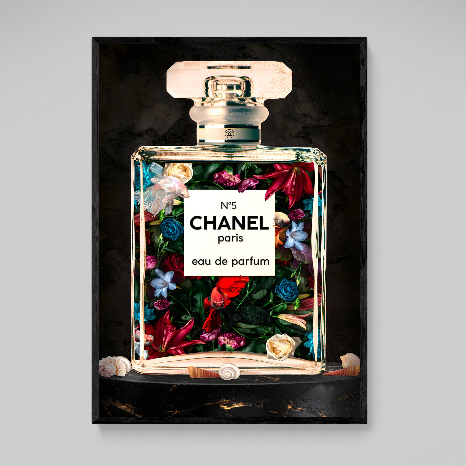 Tableau Chanel Parfum Fleurs : Un flacon de parfum Chanel n°5 rempli de fleurs et de poissons vibrants, présenté sur une surface en marbre foncé.